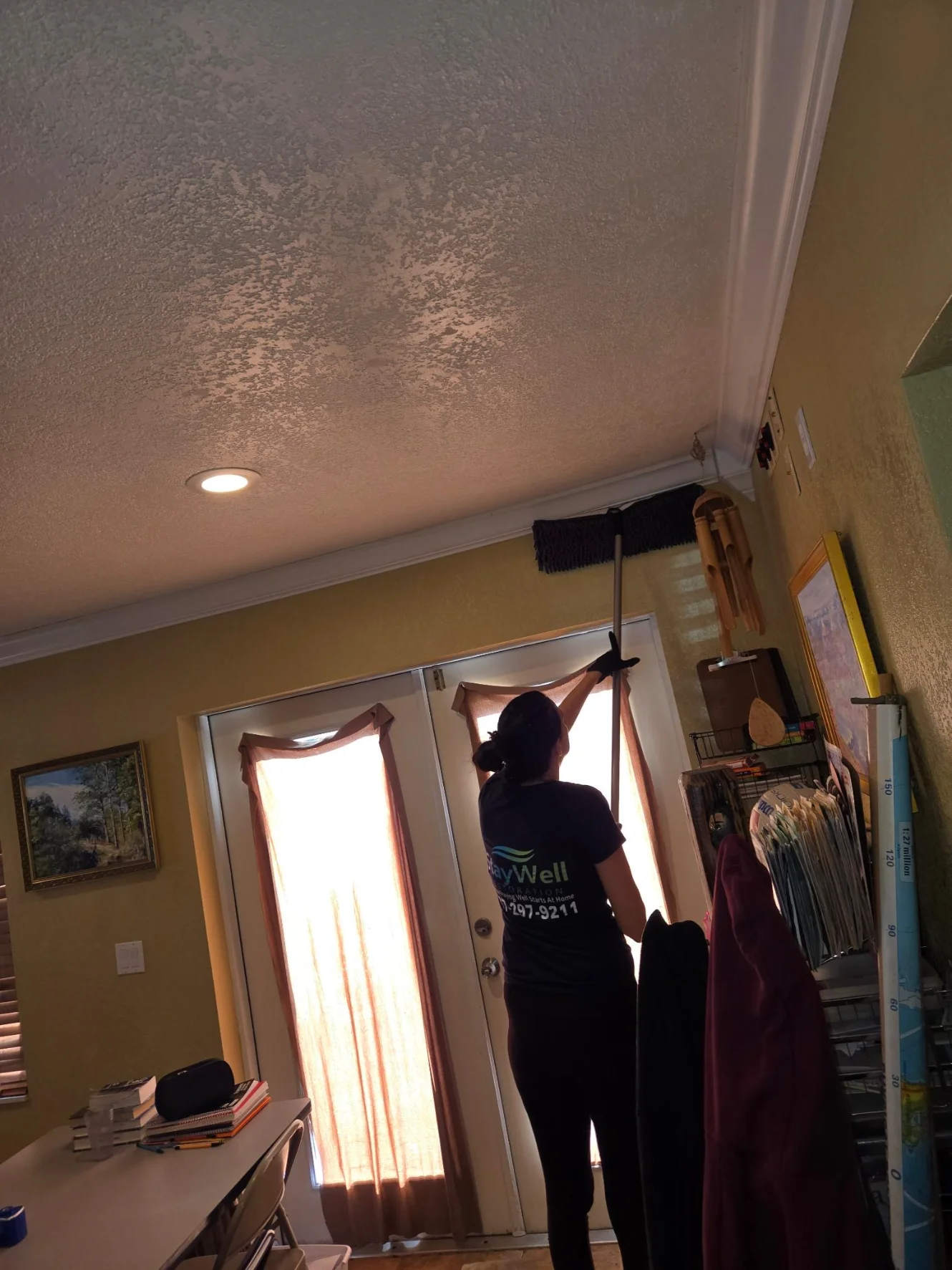 Technician inspecting ceiling and upper wall areas