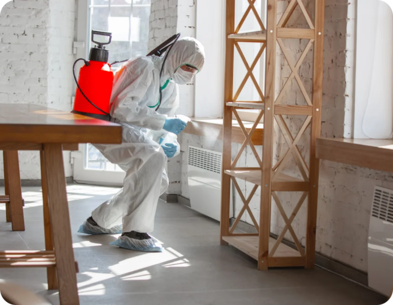 Technician in protective gear performing remediation